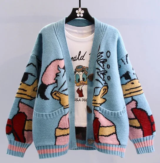 Couple's retro duck-pattern cardigan in blue with cartoon graphics, styled over a white tee, perfect for cozy outfits.