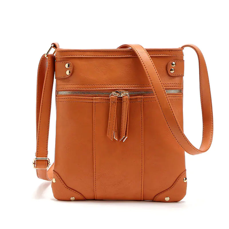 Vintage studded shoulder bag with zipper crossbody design in orange, perfect for stylish on-the-go moms.