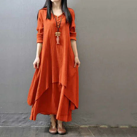 Two-piece long dress with loose sleeves in orange, featuring a layered design and stylish accessories.