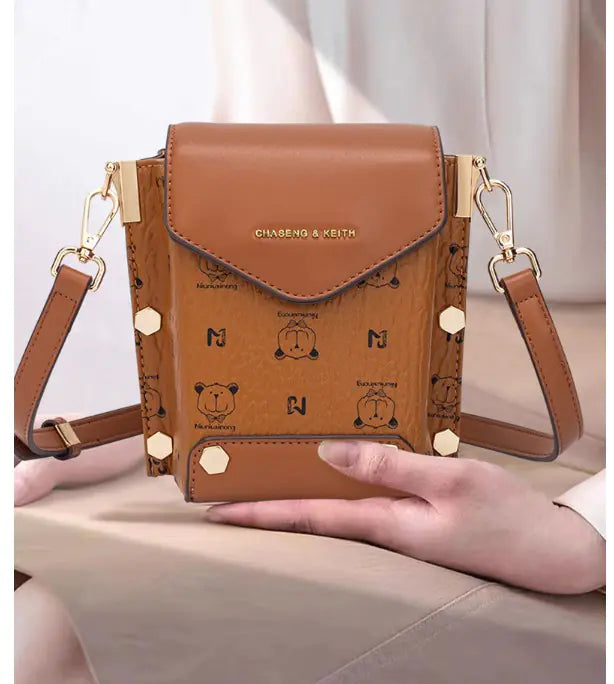 Chic brown mini crossbody bag with playful bear pattern, stylish and perfect for everyday use.