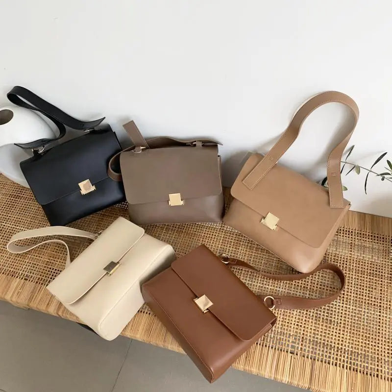 Variety of vintage leather shoulder bags for women in different colors on a stylish surface.