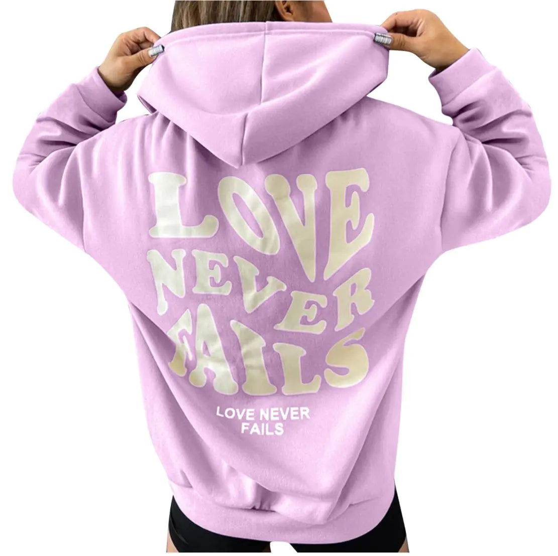 Purple hoodie with the phrase 'Love Never Fails' printed on the back, perfect for casual wear.