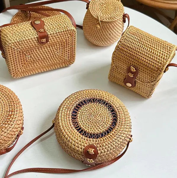 Collection of woven rattan mini bags with leather closures, showcasing vintage style and artisan craftsmanship.
