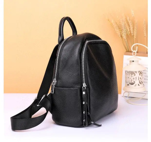 Stylish black leather backpack with zipper, perfect for college and daily use.