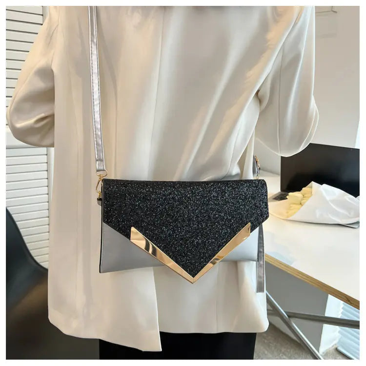 Stylish sequined women's envelope bag with gold accents, worn as a shoulder bag, perfect for any occasion.