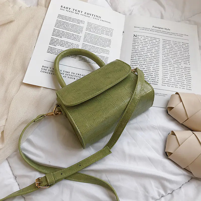 Chic mini stone pattern handbag in light green, featuring a compact design and adjustable crossbody strap.