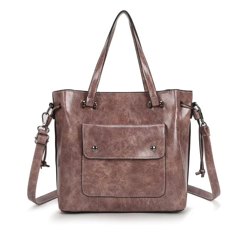 Fashion women's shoulder tote bag in brown leather with front pocket and dual-handles.