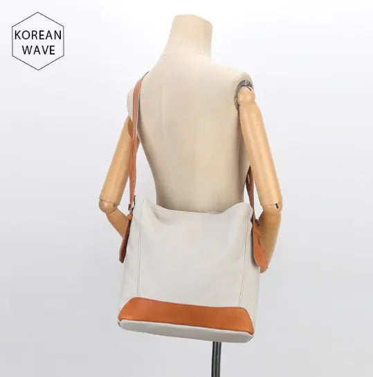 Versatile canvas shoulder and crossbody bag in beige with tan accents, perfect for daily use and stylish outings.