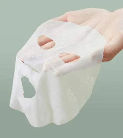 Anua HeartlePG Korean face mask in hand showcasing sheet texture.