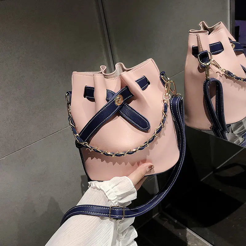 Autumn new butterfly chain nylon versatile women's bag in pink with navy accents, highlighting stylish design and practical features.