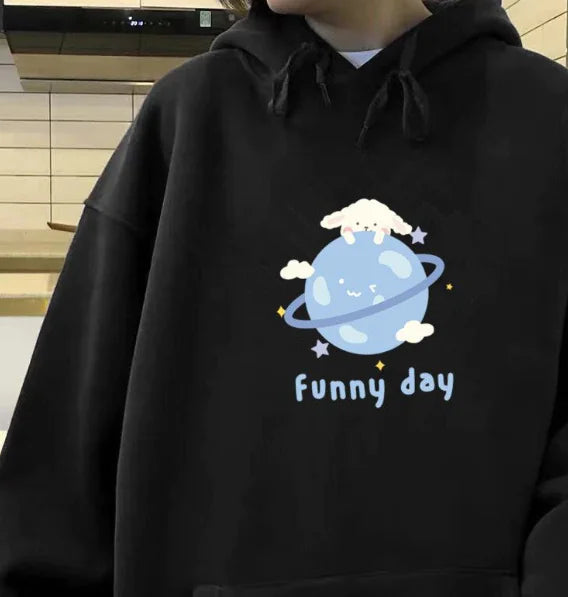 Trendy women's black hooded pullover jacket featuring a playful cartoon planet design with the text 'funny day'.