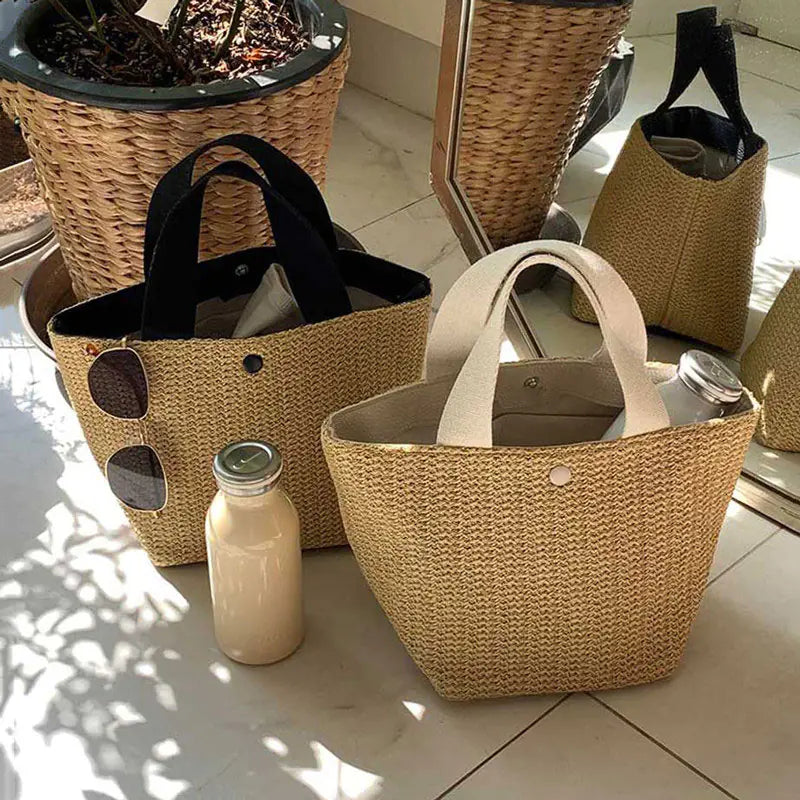 Woven grass straw tote bags in beach bucket style, perfect for summer outings and picnics.