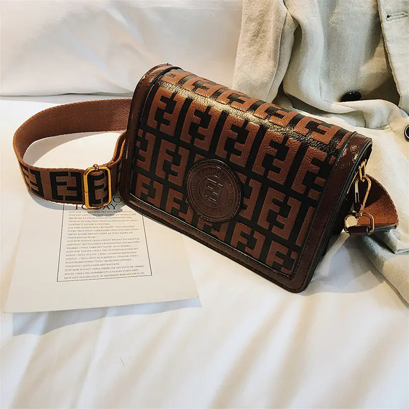 Vintage shoulder crossbody bag with logo design and elegant strap, perfect for stylish everyday use.