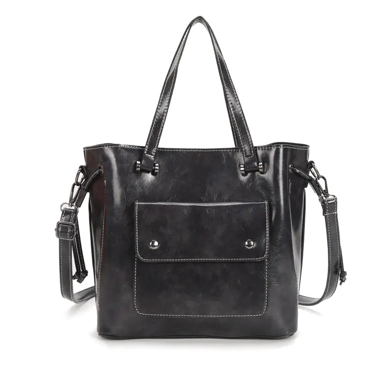 Fashion women's black leather shoulder tote bag with two-layer cowhide and stylish design for day and night.