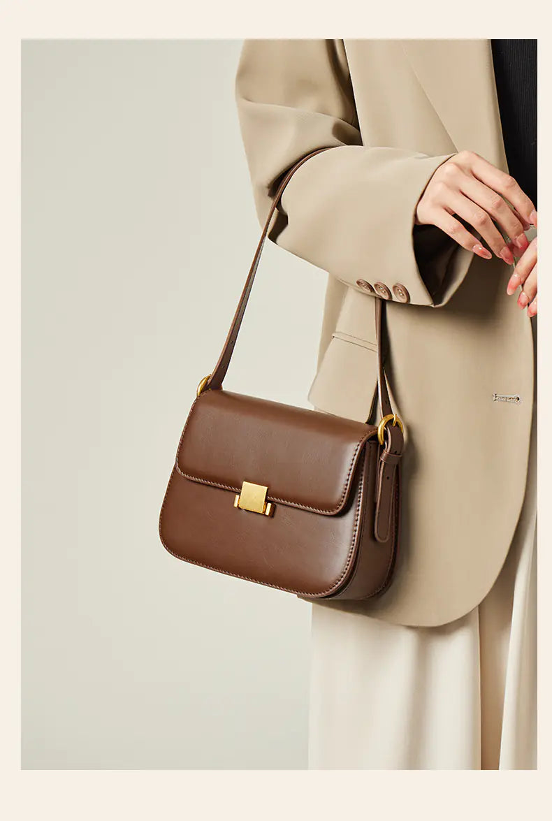 Vintage leather shoulder bag in brown, styled with a chic blazer for women.