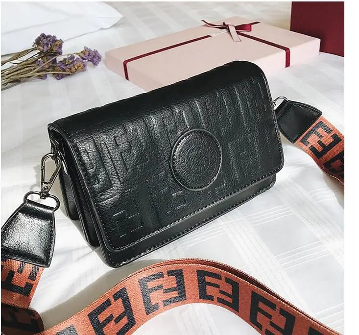 Retro style mini shoulder bag for women in black PU leather with logo strap, perfect for modern fashion.