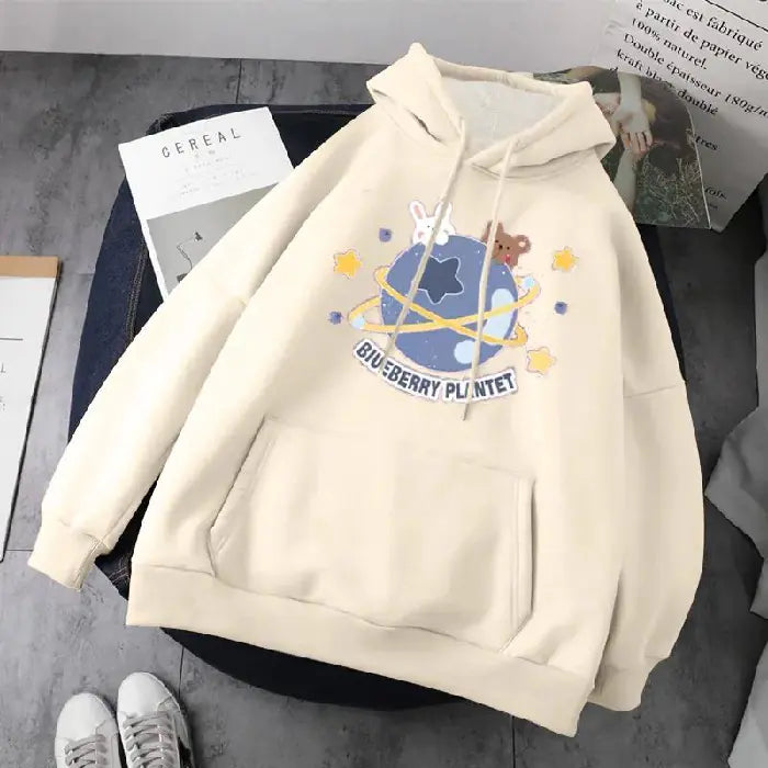 Trendy women's long-sleeved hooded pullover jacket with playful cartoon design and planets pattern.