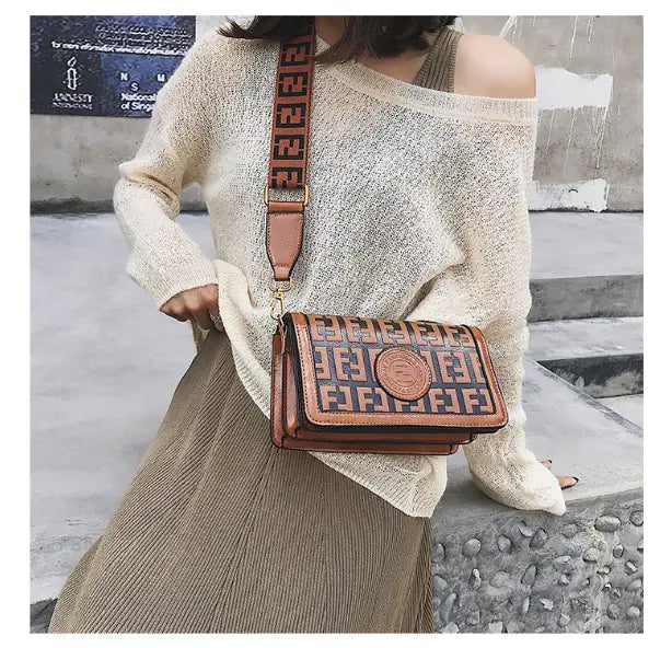 Woman wearing a cozy sweater with a retro mini shoulder bag, showcasing vintage style and modern fashion.
