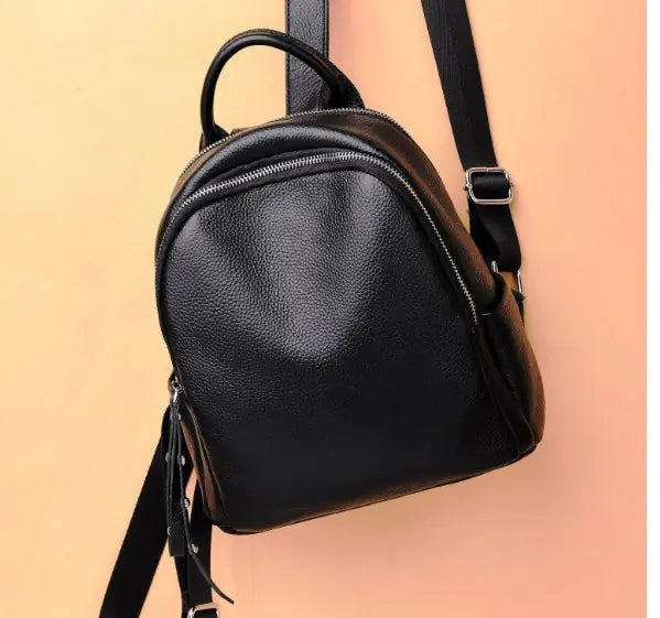 Stylish black leather backpack with zipper, perfect for college and daily use.