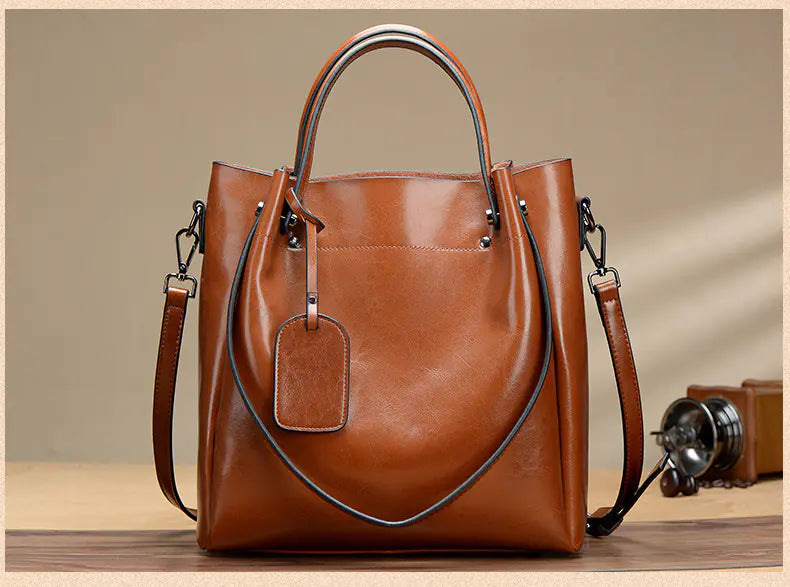 Fashion women's shoulder tote bag in brown genuine leather, featuring a stylish design and versatile functionality.