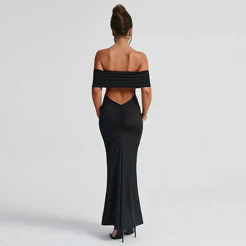 Back view of a black, backless, off-shoulder dress for women, showcasing elegant socialite style.