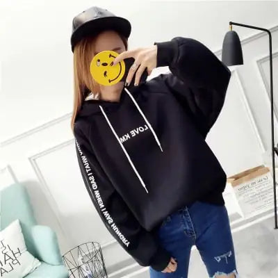 Black hooded sweatshirt with 'LOVE KAM' text and loose fit, paired with distressed jeans for a casual look.