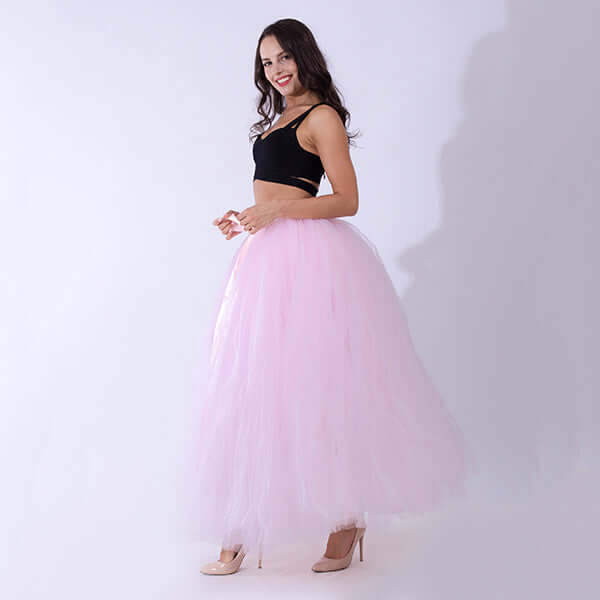 Pregnant woman dress featuring a stylish pink tulle skirt worn by a smiling model.