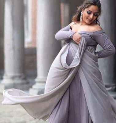 Pregnant woman cloak dress in elegant gray chiffon, showcasing long sleeves and flowing design.