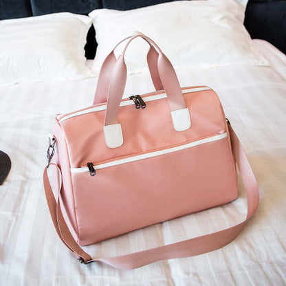 Hand-held large-capacity men's and women's body bags in pink on a bed.