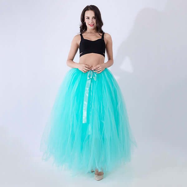 Pregnant woman dress in turquoise tulle with black top, ideal for maternity wear.