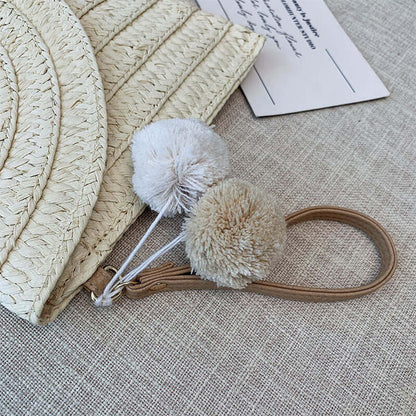 New style hand woven bags in summer featuring soft pom-pom accessories and textured design.