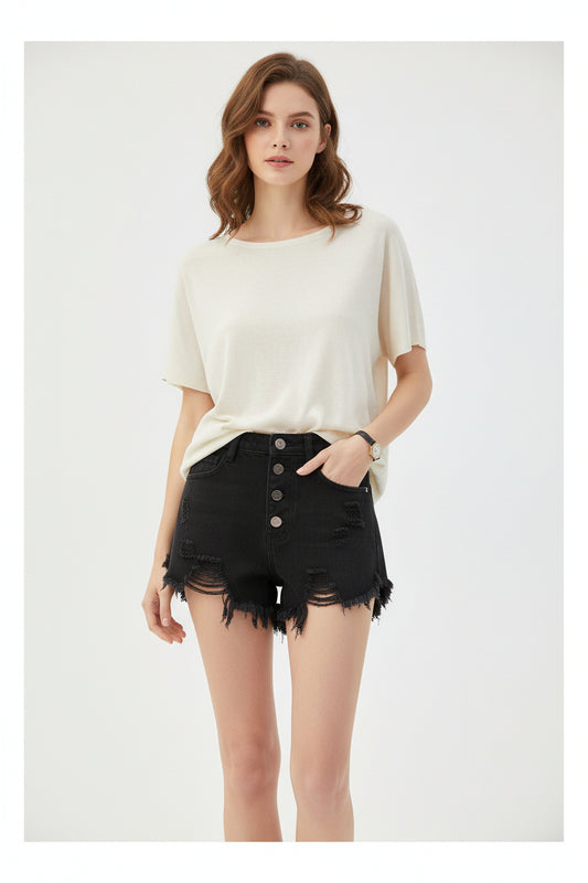 Woman Shorts featuring a black distressed design, styled with a casual cream top, perfect for summer wear.