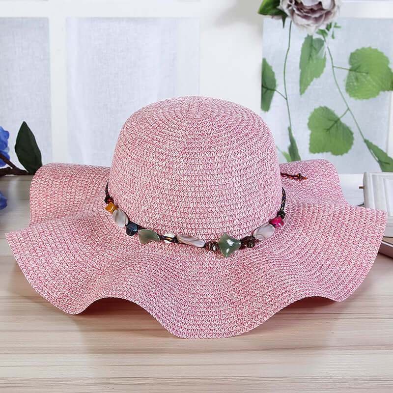 Hand-Woven Read Strange Stone Decorative Straw Hat Woman with pink color and decorative beaded band.