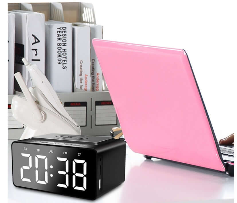 Wireless Charging Bluetooth Speaker Clock Led Alarm Clock Audio Wireless Charging Bluetooth Speaker on a desk with a laptop