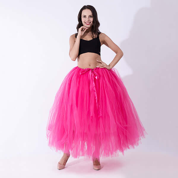 Pregnant woman dress featuring a vibrant pink tulle skirt paired with a black crop top.