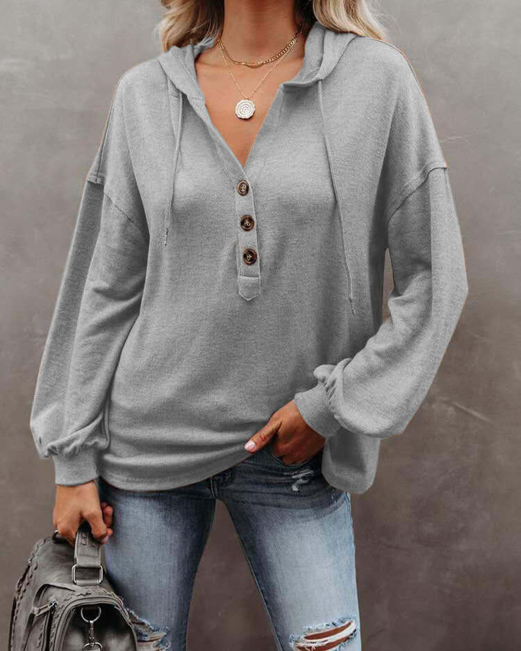 Autumn and Winter Solid Color Loose Hooded Woman in gray with button detail and long sleeves.