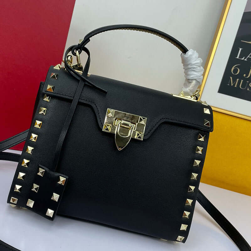 Cowhide Rivet-bound Women's Bag With Single-shoulder Messenger Pattern featuring gold studs and a lock closure.