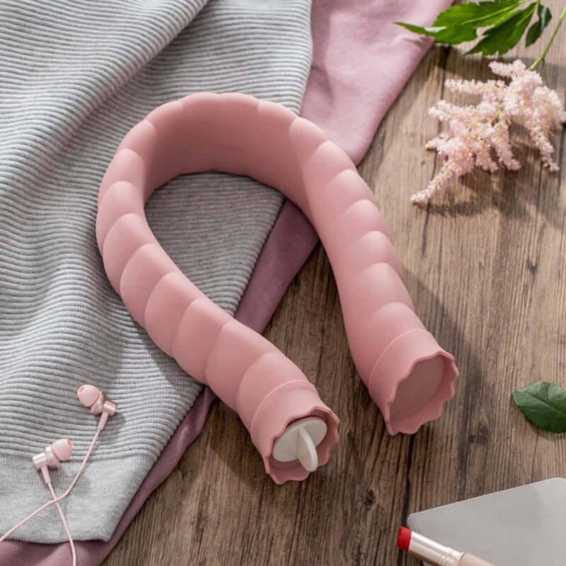 U-Shape Hot Water Bag Silicone Bottle Neck Hand Warmer Heater with Knitted Cover Water Storage Bags Keep Warm on a wooden surface.