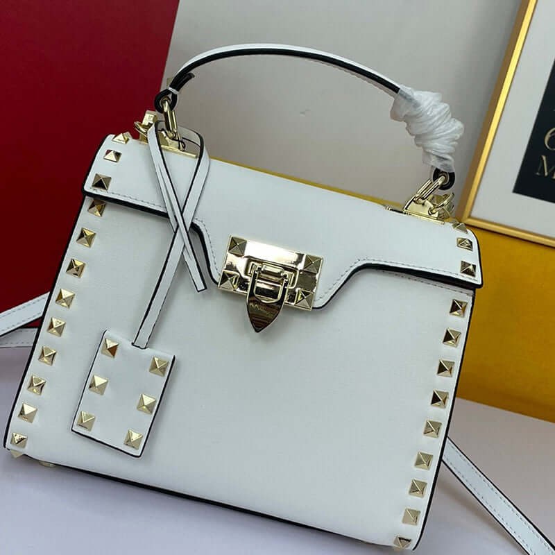 Cowhide Rivet-bound Women's Bag With Single-shoulder Messenger Pattern in white with studs and a lock closure.