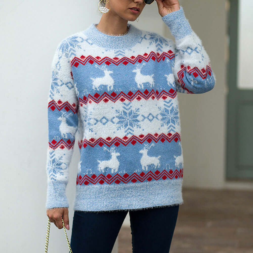 Snowflake deer pullover woman in blue featuring white deer and snowflake patterns, perfect for a casual winter look.