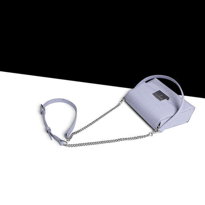 Crocodile-Pattern Leather Handbag – Versatile Carry in light lavender with chain strap laid on a contrasting background.