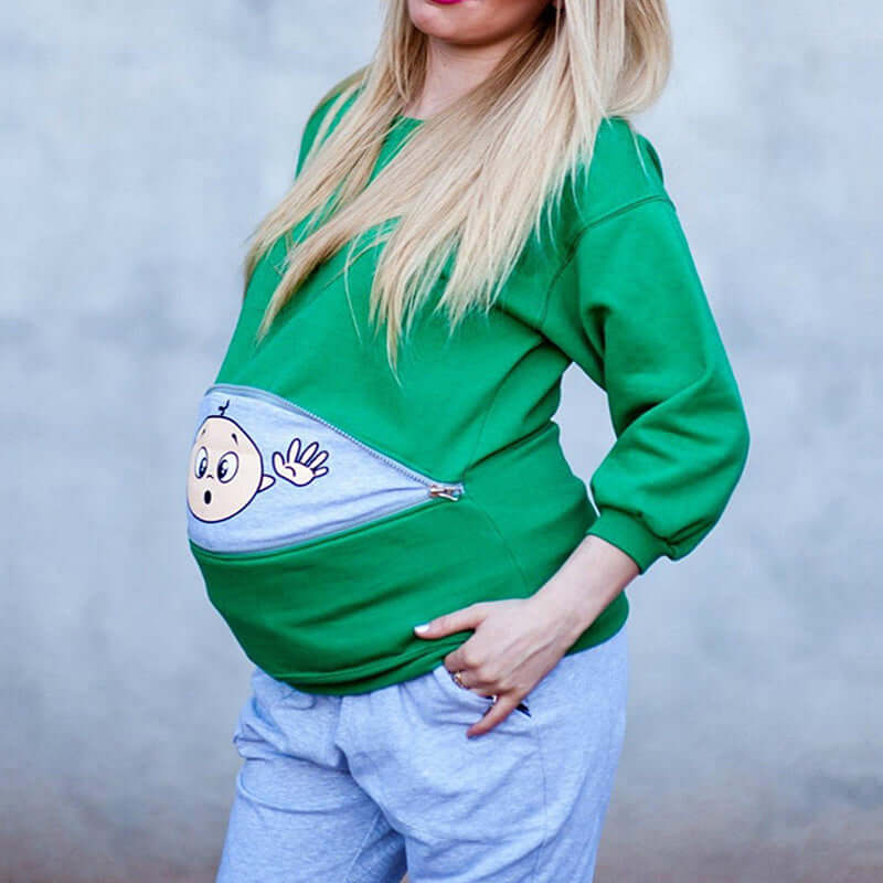 Plus size pregnant woman cartoon cute long sleeve in green sweater with cartoon baby design on belly.