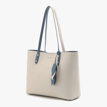 Large capacity leather handbag in a light cream color with blue straps and decorative leaf pendant.