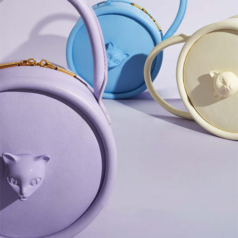 Women’s Cat Head Leather Crossbody Shoulder Bag in purple, blue, and white colors, showcasing unique cat head design.