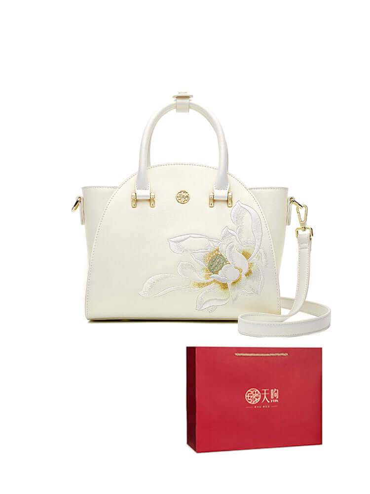 Pearl cowhide handbag with floral embroidery, stylish packaging for an elegant gift.