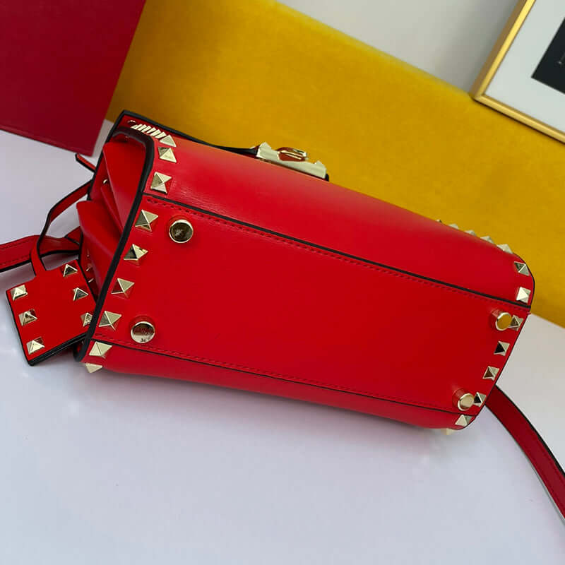 Cowhide Rivet-bound Women's Bag With Single-shoulder Messenger Pattern featuring a red design and gold studs.