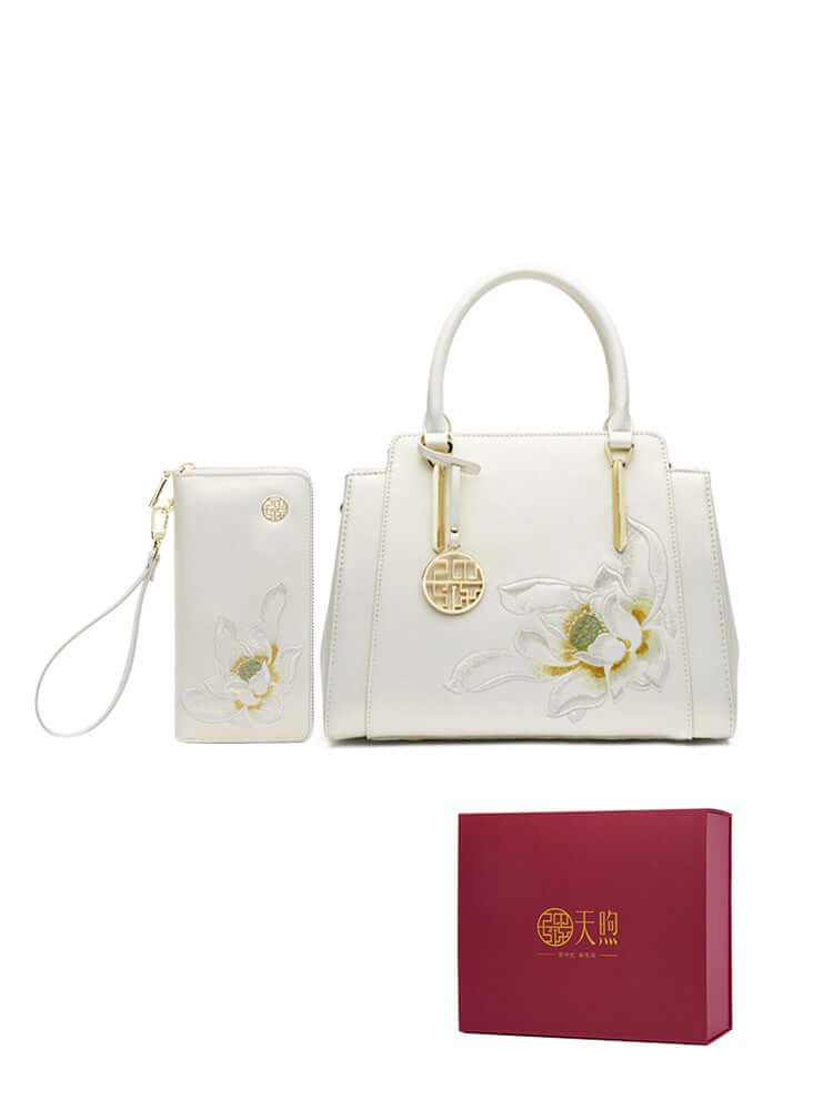 Pearl cowhide handbag with floral design and matching wallet, presented in elegant gift packaging.