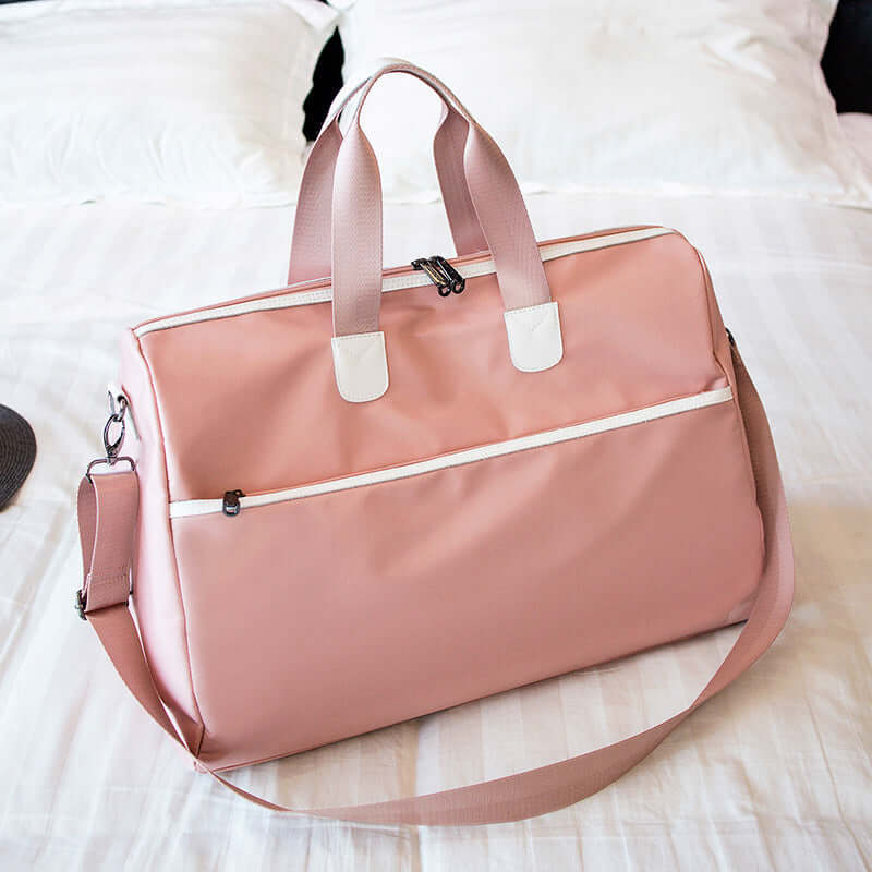 Hand-held large-capacity men's and women's body bags in pink color, showing portable design and soft handles.