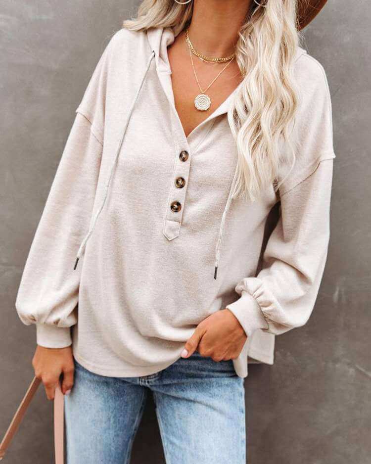 Autumn and Winter Solid Color Loose Hooded Woman wearing a beige hoodie with buttons and long sleeves.
