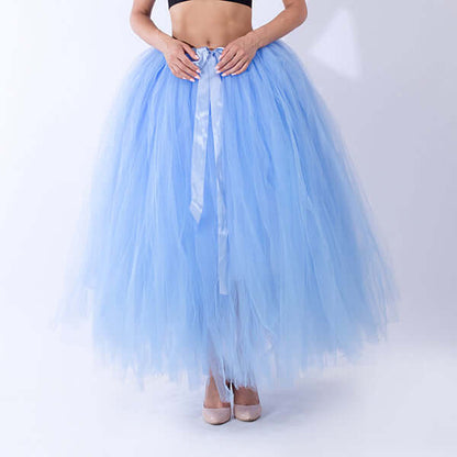 Pregnant woman dress in light blue tulle fabric, featuring a ribbon tie, perfect for maternity wear.